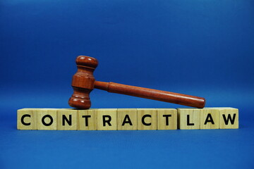 Contract Law alphabet letters with wooden blocks alphabet letters and Gavel on blue background