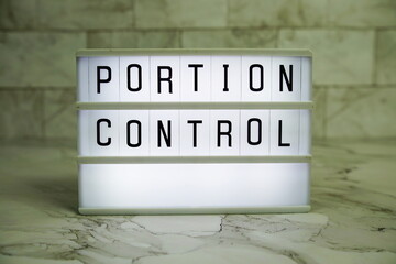 Portion ControlPortion Control letterboard text on LED Lightbox on marble background, Healthcare concept background