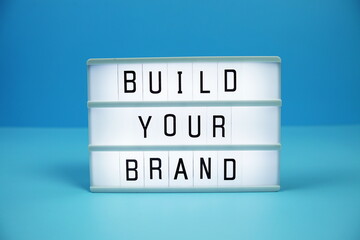 Build Your Brand letterboard text on LED Lightbox on blue background