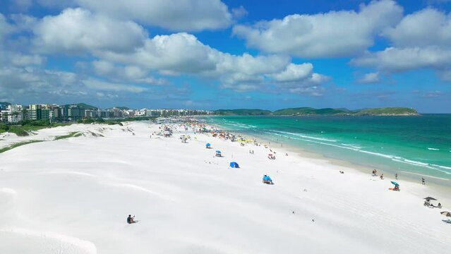 Aerial view of white dunes of the beach Cabo Frio with azure sea in Rio de Janeiro, Brazil.