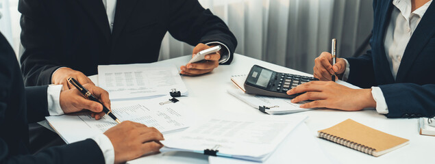 Corporate accountant team use calculator to calculate and maximize tax refunds and improve...