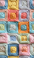 Stunning highresolution photo of an intricately crafted crochet patchwork featuring a range of soft pastelcolored squares, ideal for backgrounds and artistic endeavors