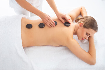 Young woman getting massaging treatment over white. Spa, healthcare and recreation concept.