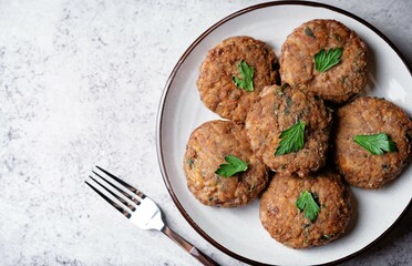 Buckwheat porridge ground meat onion burgers in a plate