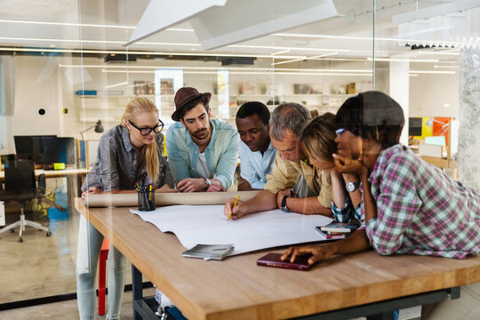 Diverse team of architects collaborating on a project in a modern office setting