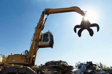 Excavator for loading scrap metal.