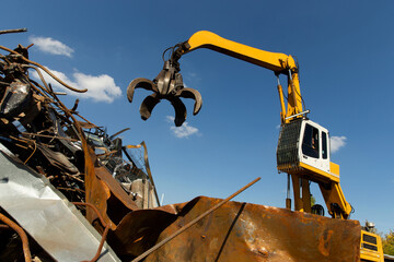 Excavator for loading scrap metal.