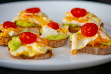 Healthy breakfast, toast with avocado, eggs and tomatoes
