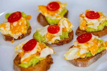 Healthy breakfast, toast with avocado, eggs and tomatoes