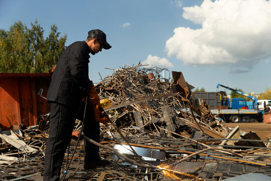 A man cuts metal with a gas torch.