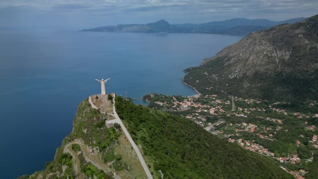 Aerial shot of Christ the Redeemer of Maratea overlooking the cliff,
Italy Basilicata
