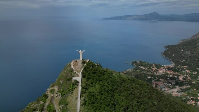 Aerial shot of Christ the Redeemer of Maratea overlooking the cliff,
Italy Basilicata
