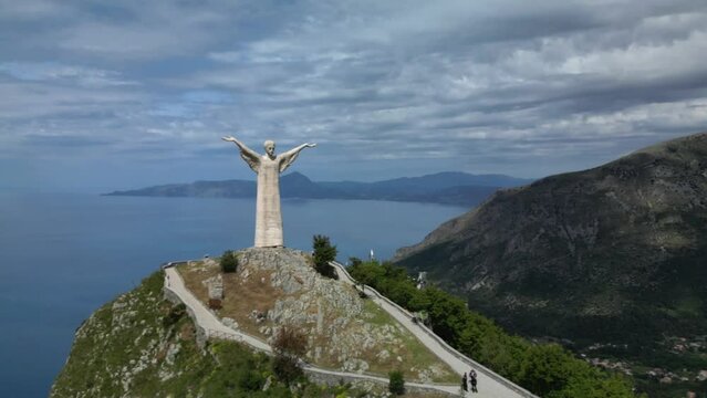 Aerial shot of Christ the Redeemer of Maratea overlooking the cliff,
Italy Basilicata
