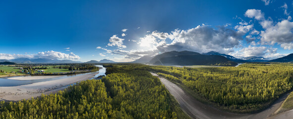 Aerial Panorama of River and Canadian Mountain Landscape. Sunny Cloudy Evening