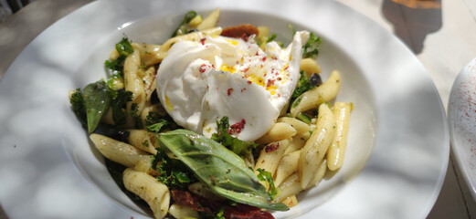 burrata with penne pasta as italian food