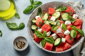 A bowl of watermelon salad with cucumbers and feta cheese
