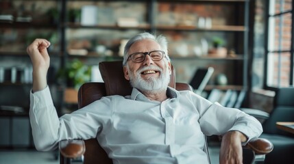 Fototapeta premium Senior Businessman Celebrating Success in Modern Office Environment