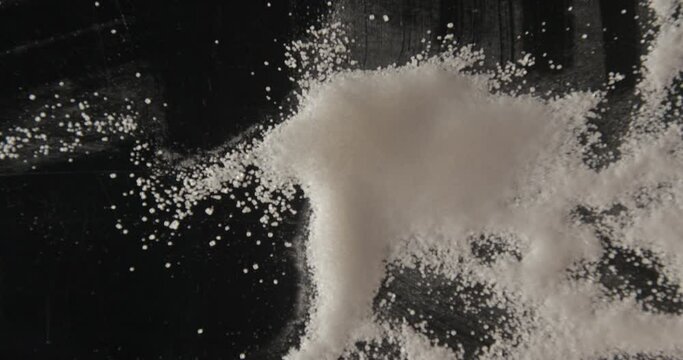 White sugar pouring and mixed with hands from below 4K pro res