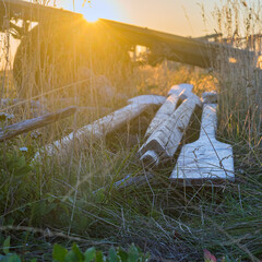 Antique wooden oars. Oars for an old boat. The setting sun is on the background