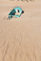 Beached old abandoned boat on the seashore stranded and full of sand in Punta Paloma on a bright...