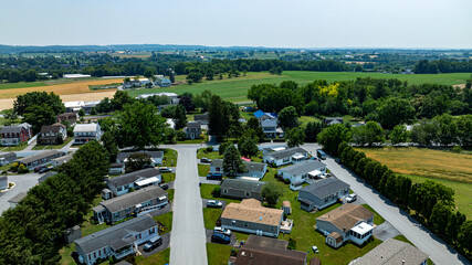 Overhead aerial view of a suburban Mobile, Prefab, Manufactured, neighborhood park, featuring rows...