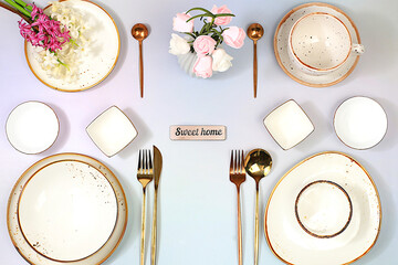 Cutlery with flowers on a plate on a marble background. Elegant festive table setting, menu layout...
