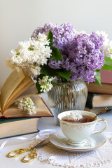 Cup of tea, bouquet of lilacs, spring still life.