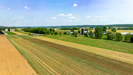 A large field with a few houses in the distance