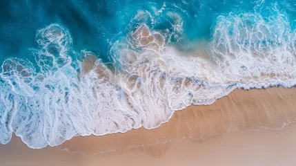 Selbstklebende Fototapeten Sweeping aerial view of a beach with rolling blue waves, perfect for illustrating the tranquility and beauty of a summer vacation spot © JP STUDIO LAB