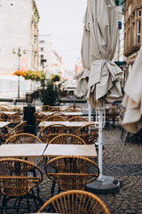 Outdoor street cafe tables ready for service. Modern Empty cafe terrace with table and chair, morning time. Food concept. Cafeteria, Outside Trattoria