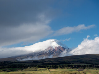 Fototapeta premium Landscape Cotopaxi volcano in Ecuador covered with clouds during a sunny day
