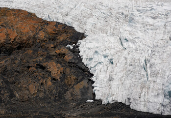 Detail of a glacier on a rocky mountain surface retreating