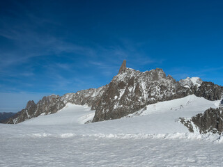 Dente del Gigante (also known as Dent du Geant), a mountain in the snow capped Mont Blanc massif in the Graian Alps of France and Italy, seen from near Pointe Helbronner