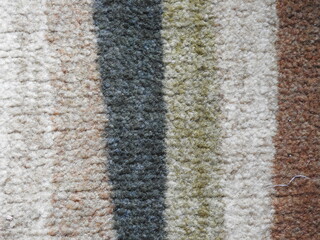 close up of a carpet texture stripes background white tan gray brown