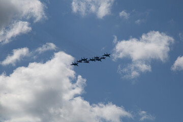 Fighter jets are flying over the city.