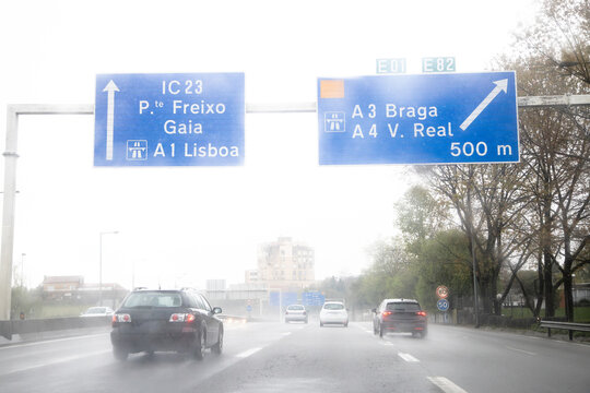 Image of the section of the internal beltway, VCI, Porto, Portugal. Local traffic during a day of bad weather conditions with heavy rain. Information panel, directions.