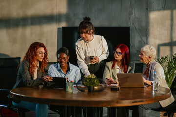 Diverse female team brainstorming and collaborating on a project.