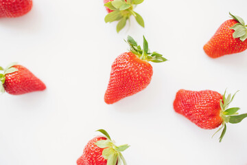 Ripe juicy strawberries on a white background. pattern. Creative summer background composition with strawberry. Minimal fruit concept. 
