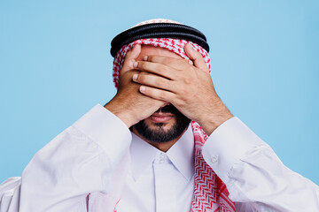 Muslim man covering eyes with palms while showing see no evil three wise monkeys concept. Person...