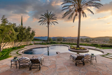 Pool Surrounded by Palm Trees and Lawn Chairs
