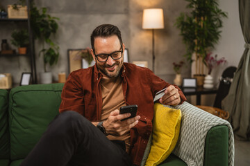 Portrait of adult man shop online with cellphone and hold credit card