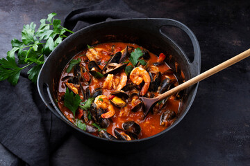 Traditional Creole cajun court bouillon with mussels and prawn gumbo chowder stew as close-up in a...