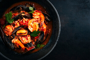 Traditional Creole cajun court bouillon with rice, mussels and prawn gumbo chowder stew as top view...
