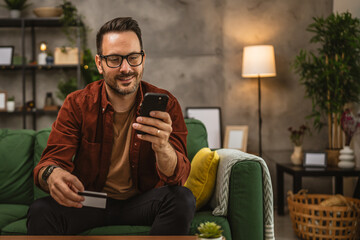 Portrait of adult man shop online with cellphone and hold credit card