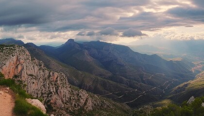 panoramic view of a majestic mountain range with cloudy cinematic sky and lighting mirador de garbi...