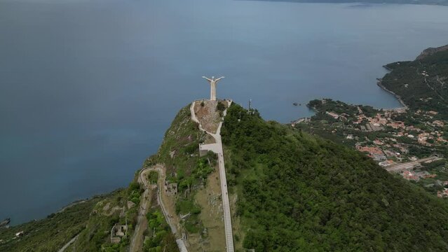 Aerial shot of Christ the Redeemer of Maratea overlooking the cliff,
Italy Basilicata
