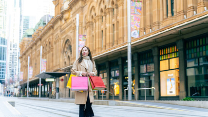 Portrait of Happy Asian woman holding shopping bag walking and shopping in the city together....
