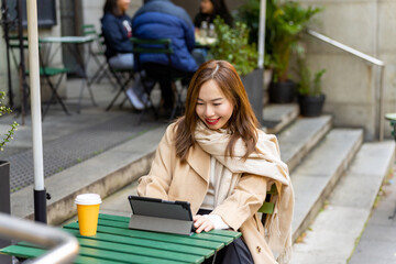 Asian businesswoman remote working on digital tablet for online corporate business economic...