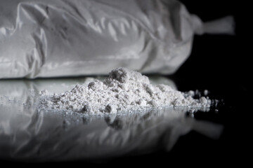 plastic bag of wheat flour isolated on dark background
