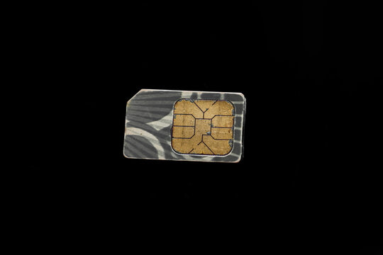 sim card isolated on black, used mobile phone sim card macro isolated on black